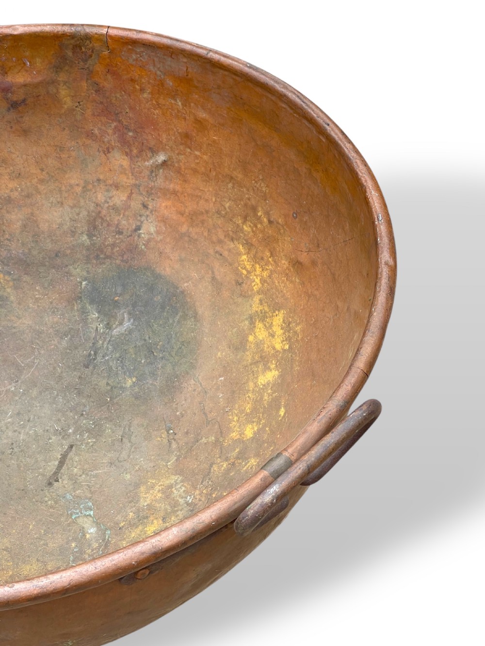 A large nineteenth-century hand-hammered copper bowl with rolled rim edges and two side loop handles. View VII
