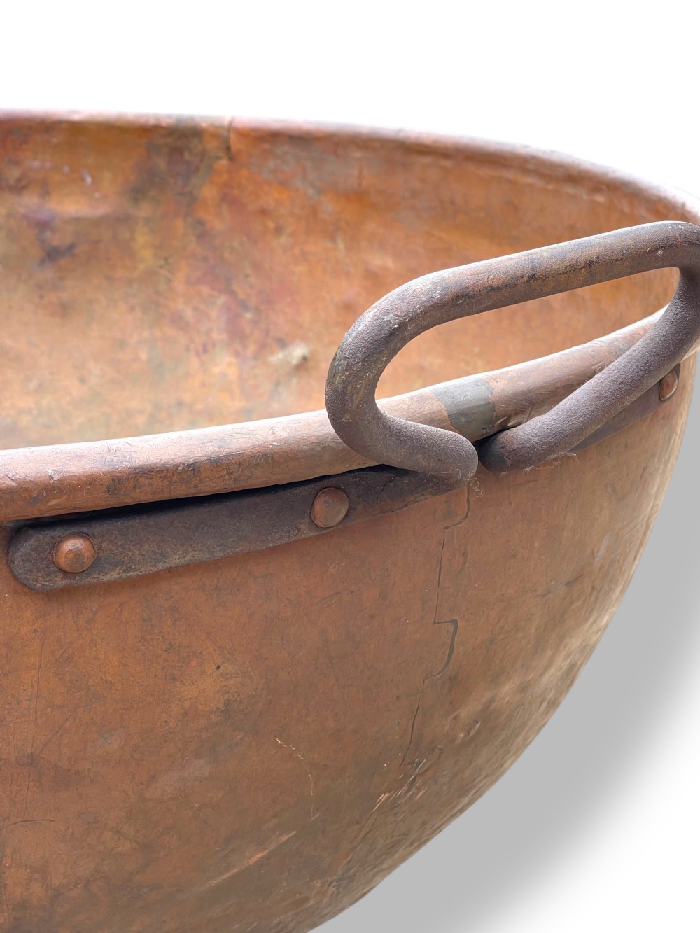 A large nineteenth-century hand-hammered copper bowl with rolled rim edges and two side loop handles. View VIII