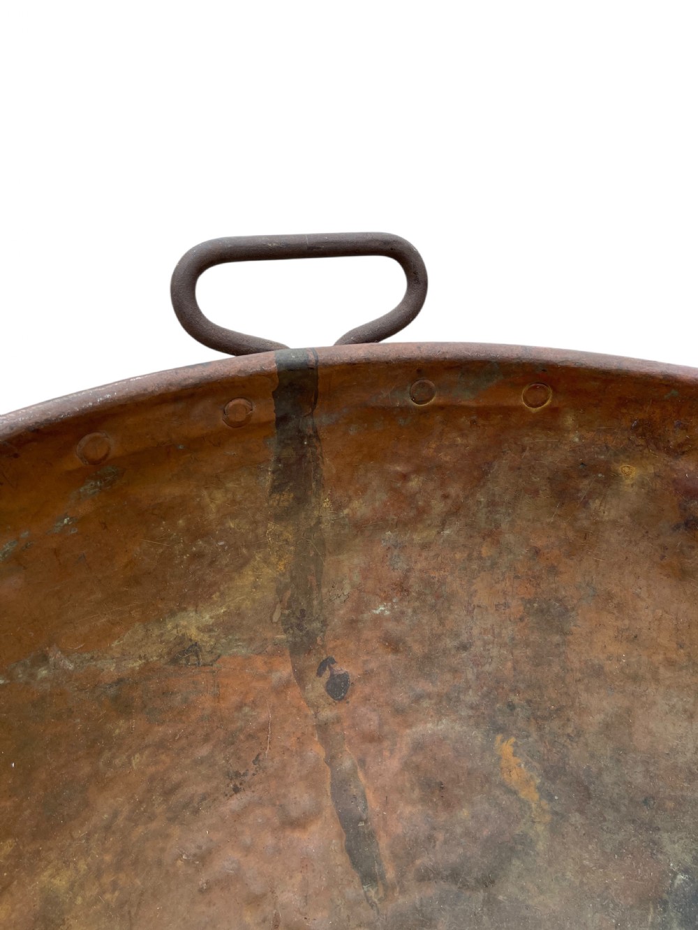 A large nineteenth-century hand-hammered copper bowl with rolled rim edges and two side loop handles. View X