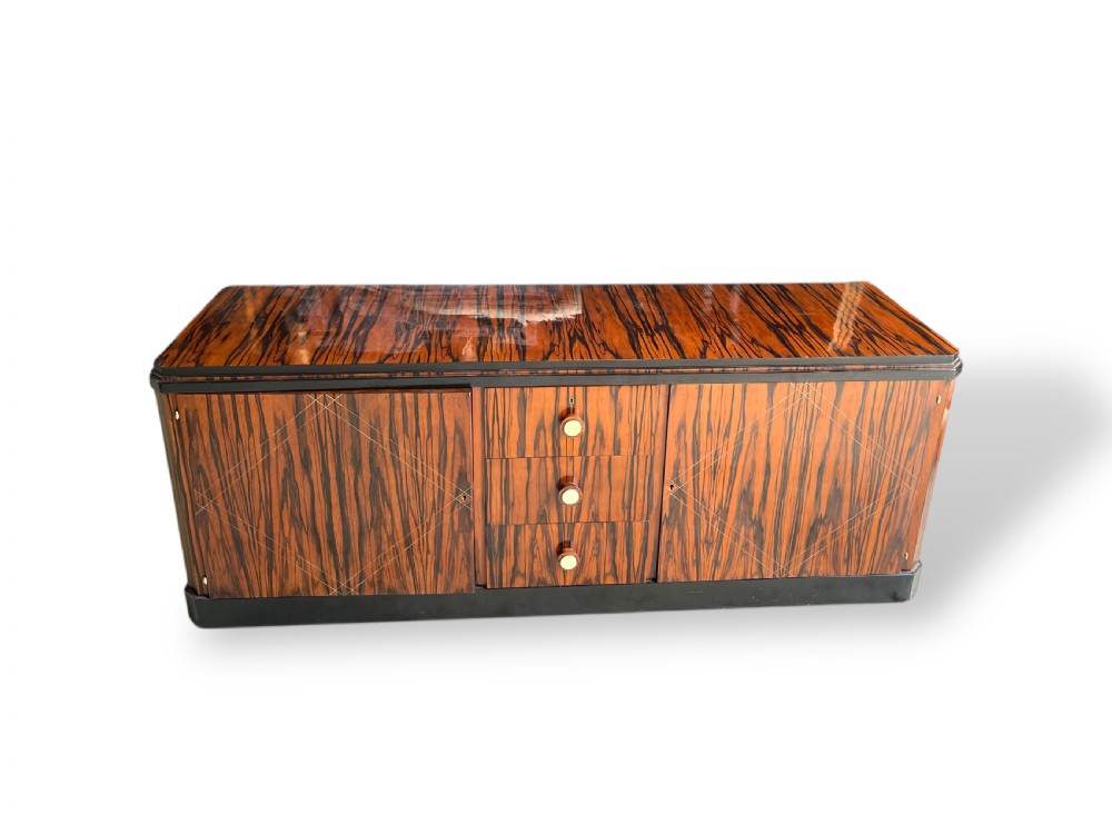 A low-profile French Art Deco sideboard in high-gloss Macassar ebony veneer with central drawers and geometric side door details. View II