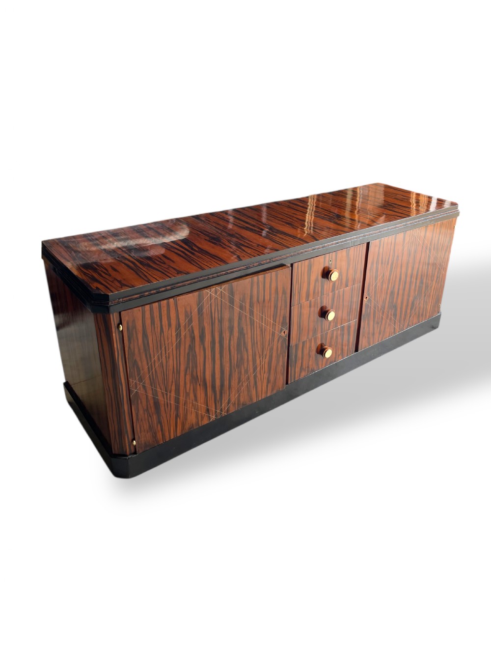 A low-profile French Art Deco sideboard in high-gloss Macassar ebony veneer with central drawers and geometric side door details. View III