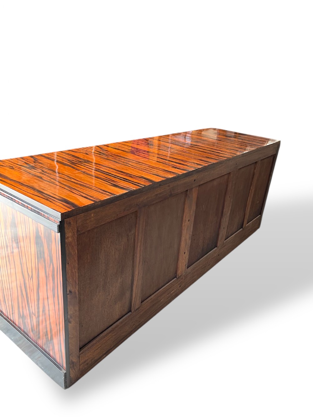 A low-profile French Art Deco sideboard in high-gloss Macassar ebony veneer with central drawers and geometric side door details. View IV
