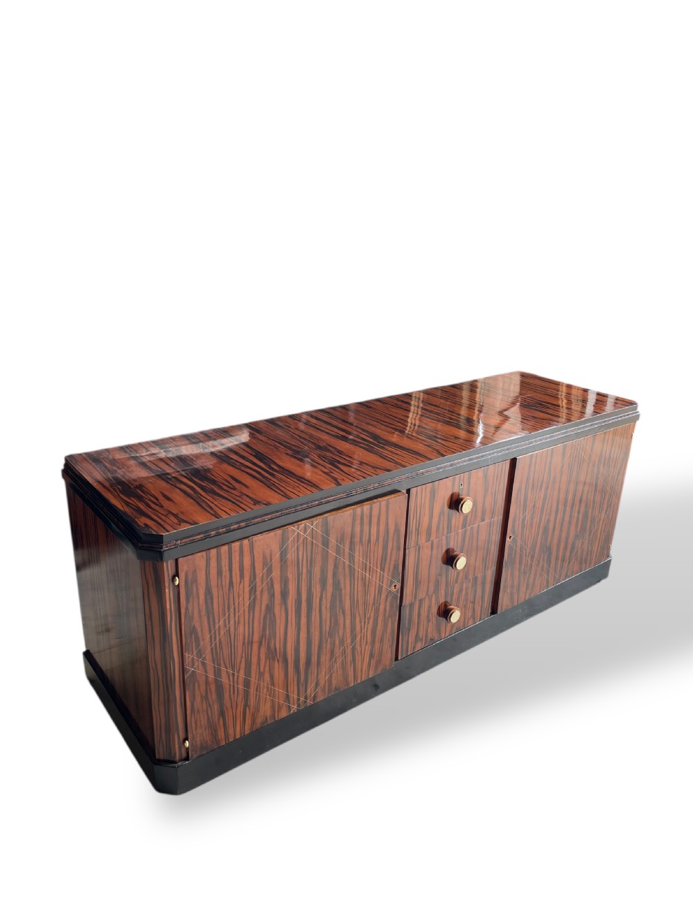A low-profile French Art Deco sideboard in high-gloss Macassar ebony veneer with central drawers and geometric side door details. View VII