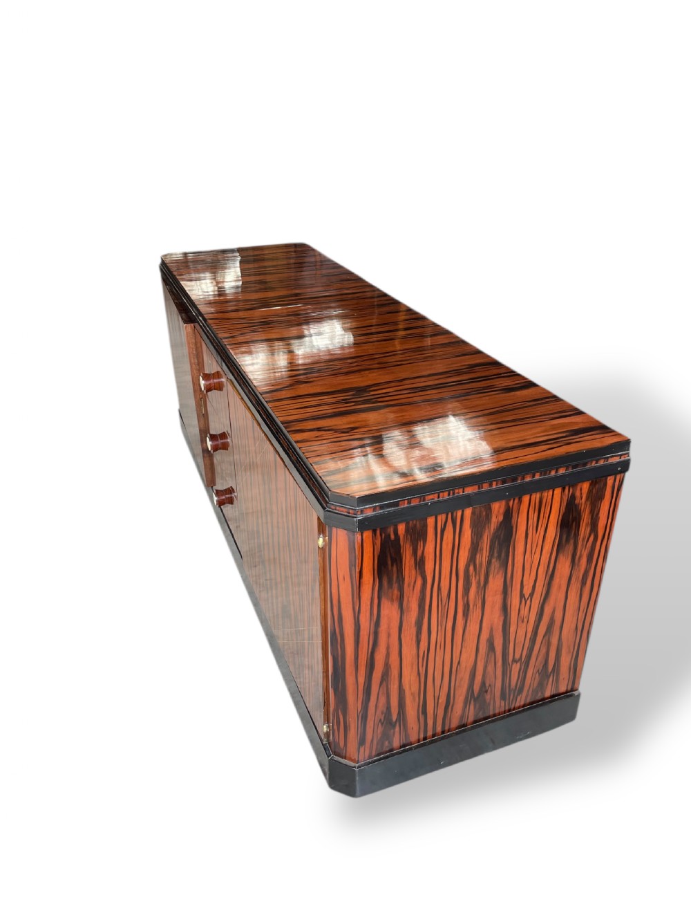 A low-profile French Art Deco sideboard in high-gloss Macassar ebony veneer with central drawers and geometric side door details. View VIII