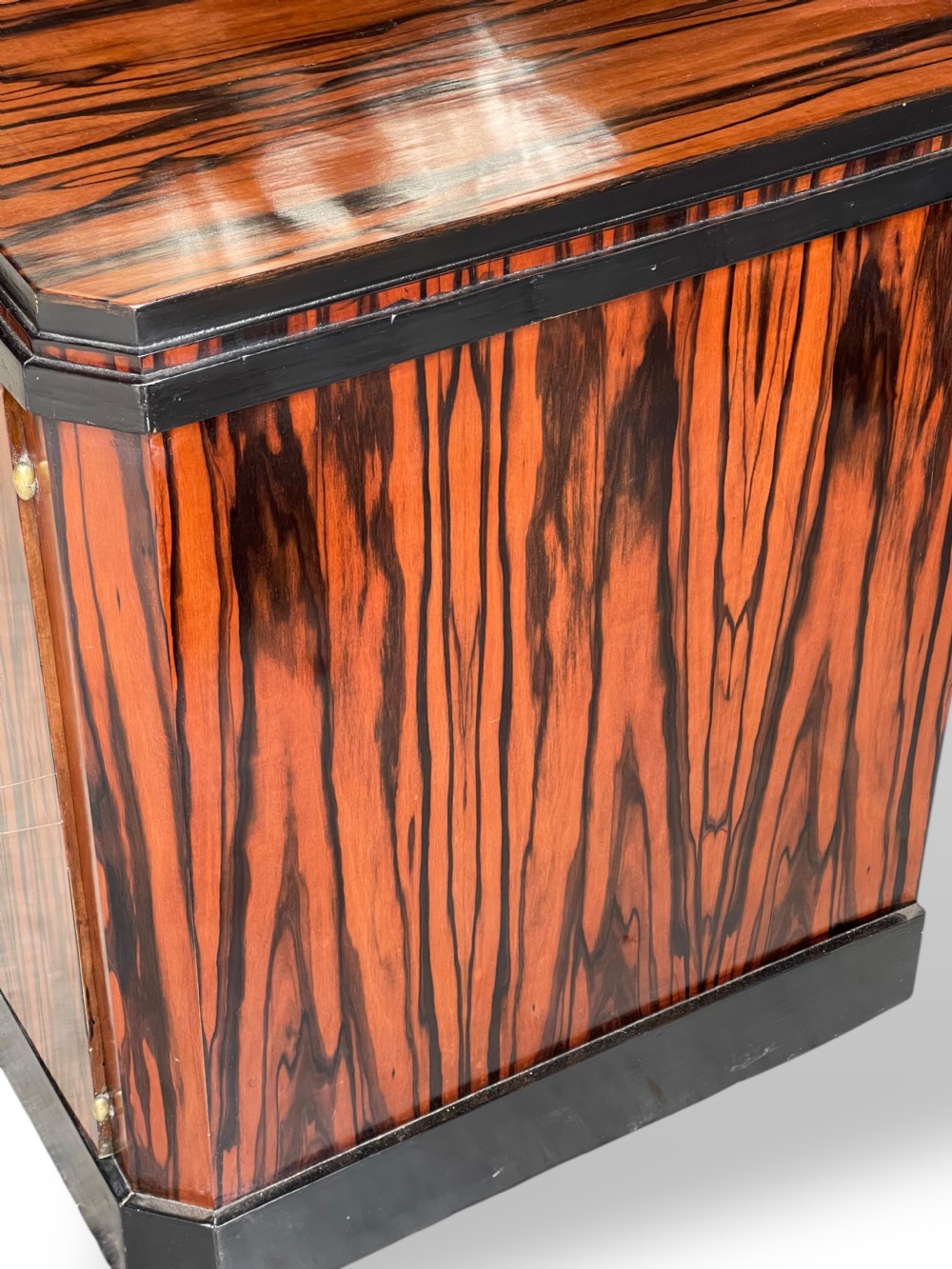 A low-profile French Art Deco sideboard in high-gloss Macassar ebony veneer with central drawers and geometric side door details. View IX