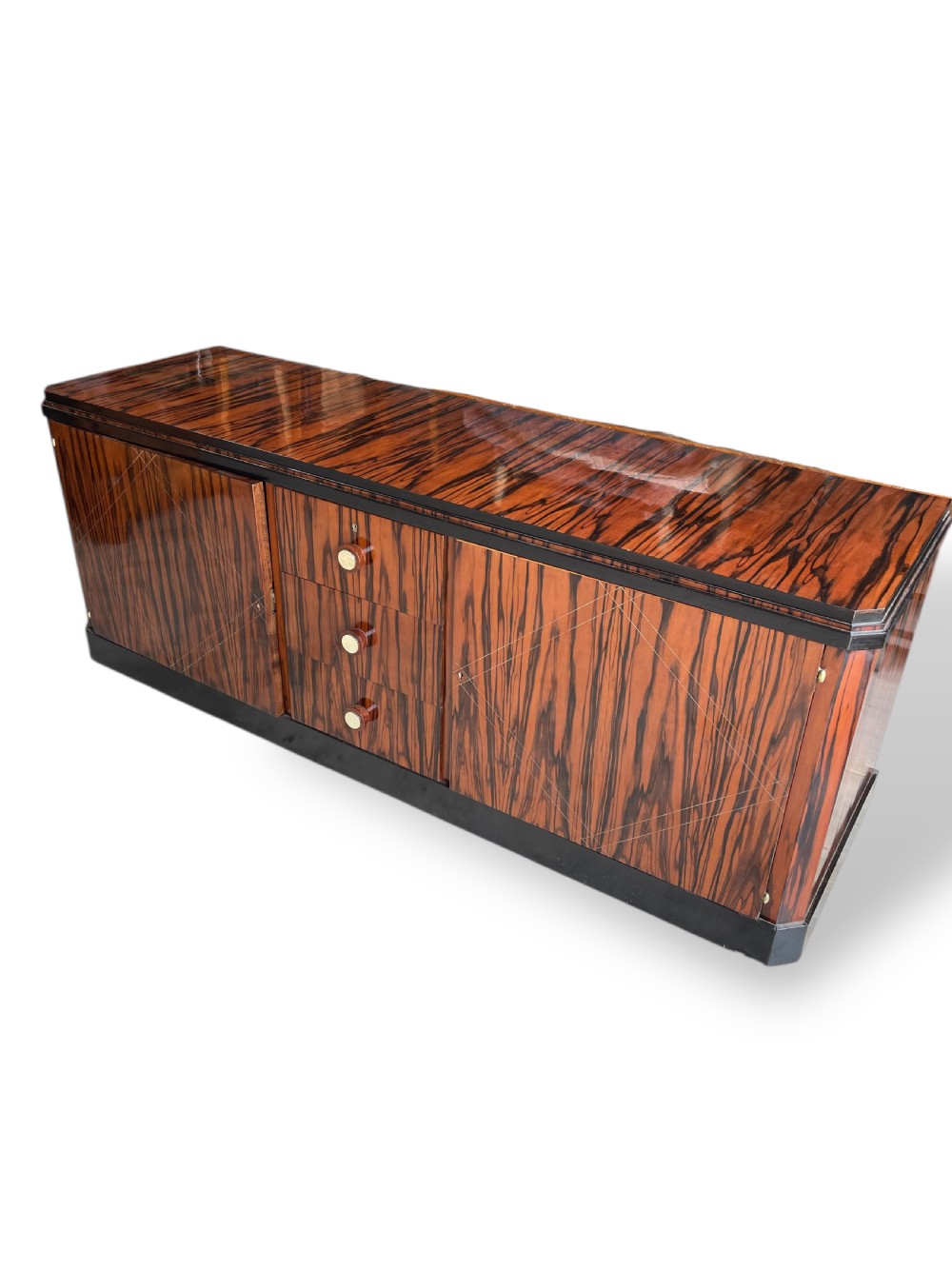 A low-profile French Art Deco sideboard in high-gloss Macassar ebony veneer with central drawers and geometric side door details. View XI