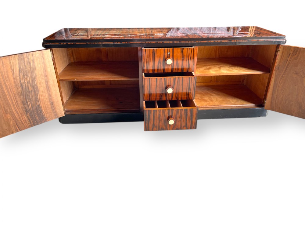 A low-profile French Art Deco sideboard in high-gloss Macassar ebony veneer with central drawers and geometric side door details. View XIII