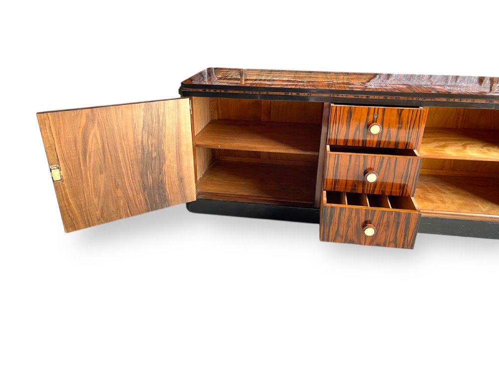 A low-profile French Art Deco sideboard in high-gloss Macassar ebony veneer with central drawers and geometric side door details. View XIV