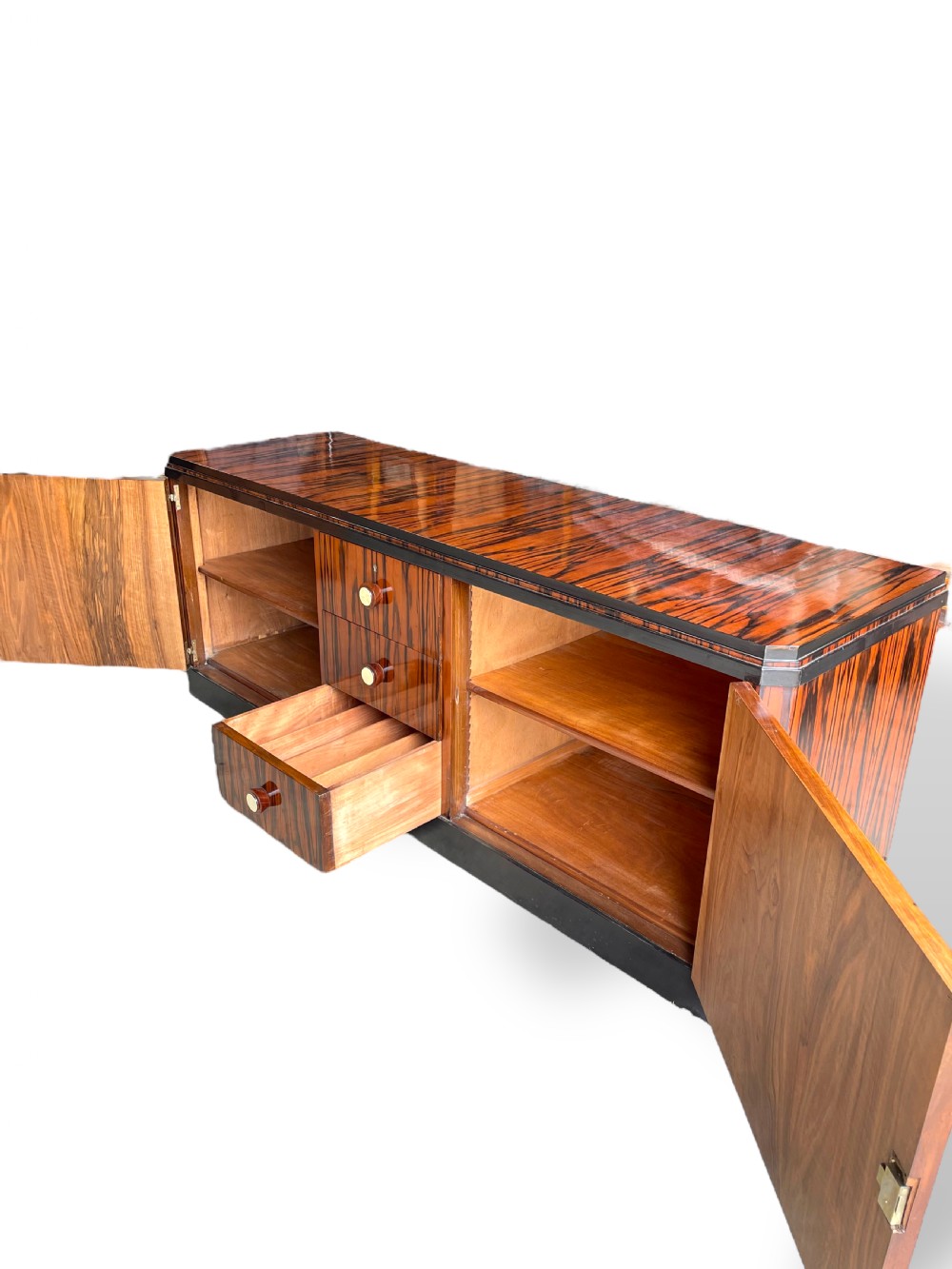 A low-profile French Art Deco sideboard in high-gloss Macassar ebony veneer with central drawers and geometric side door details. View XVII