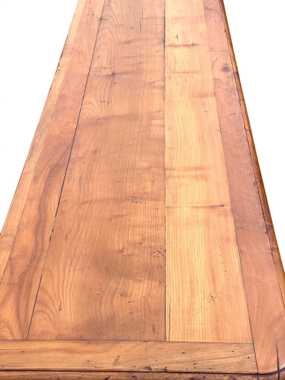 A French provincial cherrywood serving table featuring three drawers with brass drop handles, a hand-carved central shell motif on the apron, and slender cabriole legs. View XII