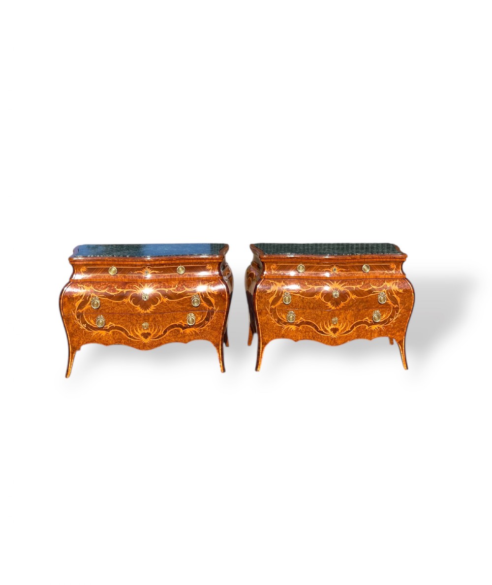 A pair of Italian bombe commodes featuring intricate floral marquetry timber inlays, dark green marble tops, and brass handles.
