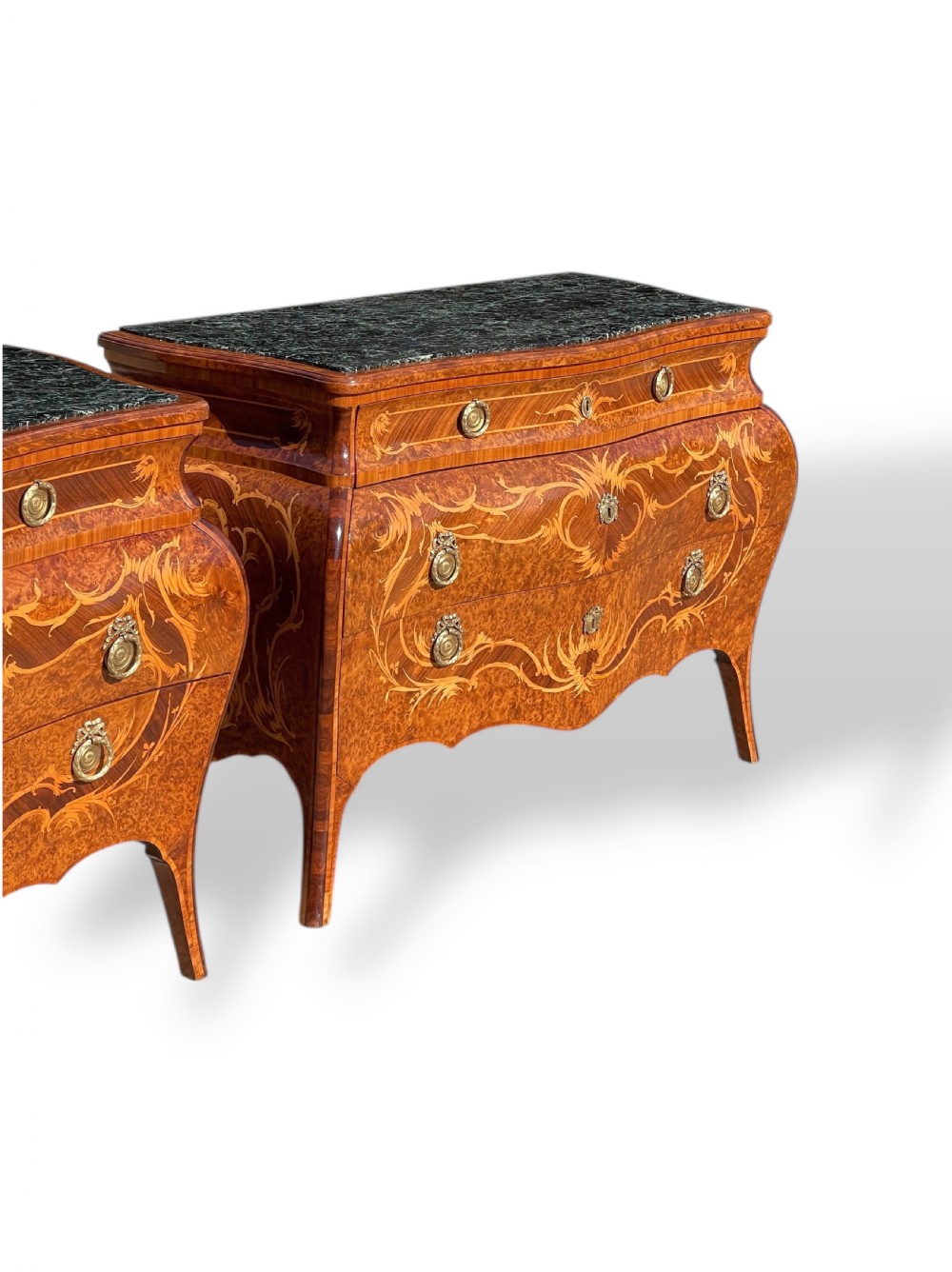 A pair of Italian bombe commodes featuring intricate floral marquetry timber inlays, dark green marble tops, and brass handles. View V