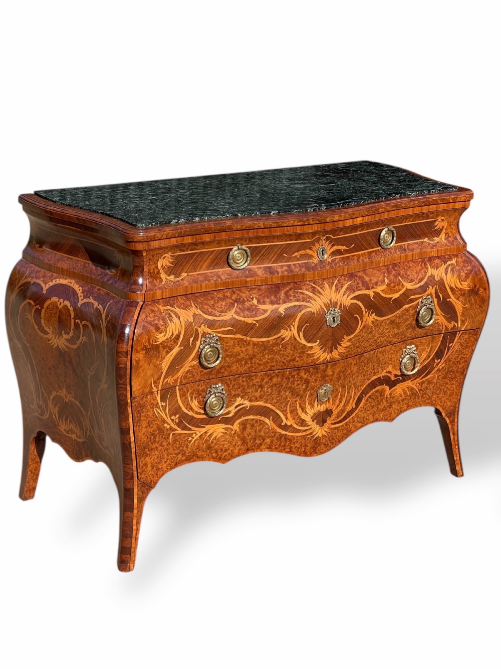A pair of Italian bombe commodes featuring intricate floral marquetry timber inlays, dark green marble tops, and brass handles. View VI
