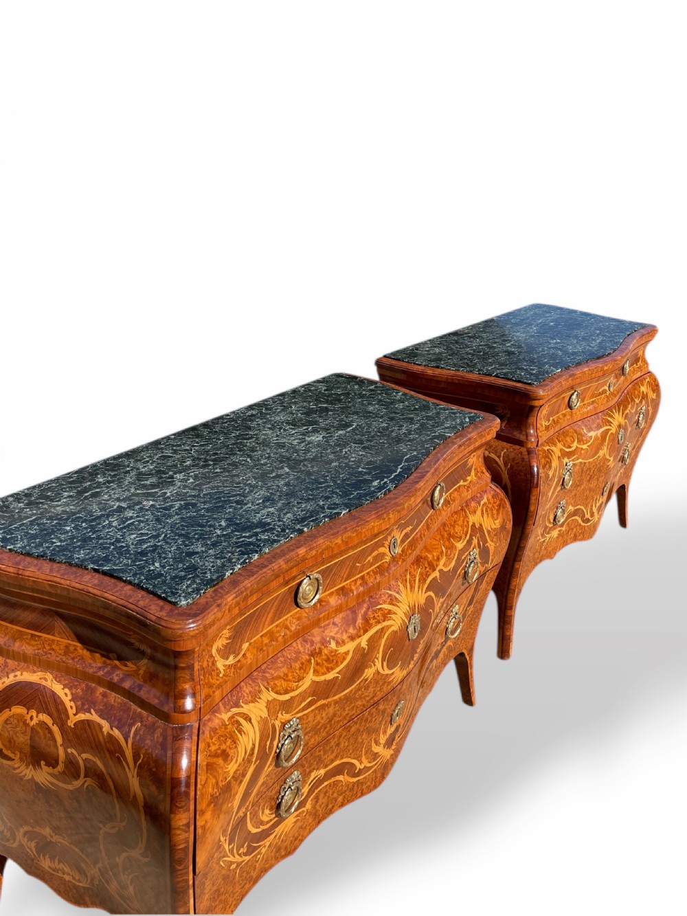 A pair of Italian bombe commodes featuring intricate floral marquetry timber inlays, dark green marble tops, and brass handles. View VII