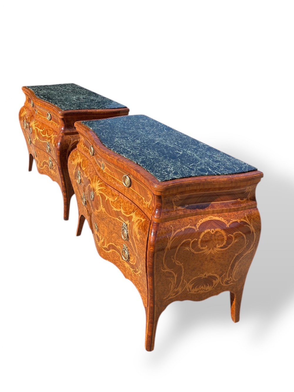 A pair of Italian bombe commodes featuring intricate floral marquetry timber inlays, dark green marble tops, and brass handles. View XIV