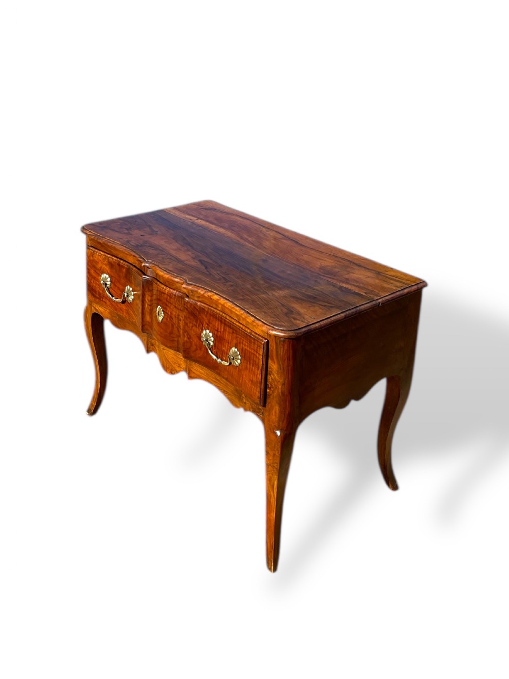 An 18th-century French walnut side table featuring a contoured serpentine front, single drawer with decorative brass handles, a shaped apron, and curved cabriole legs. View II