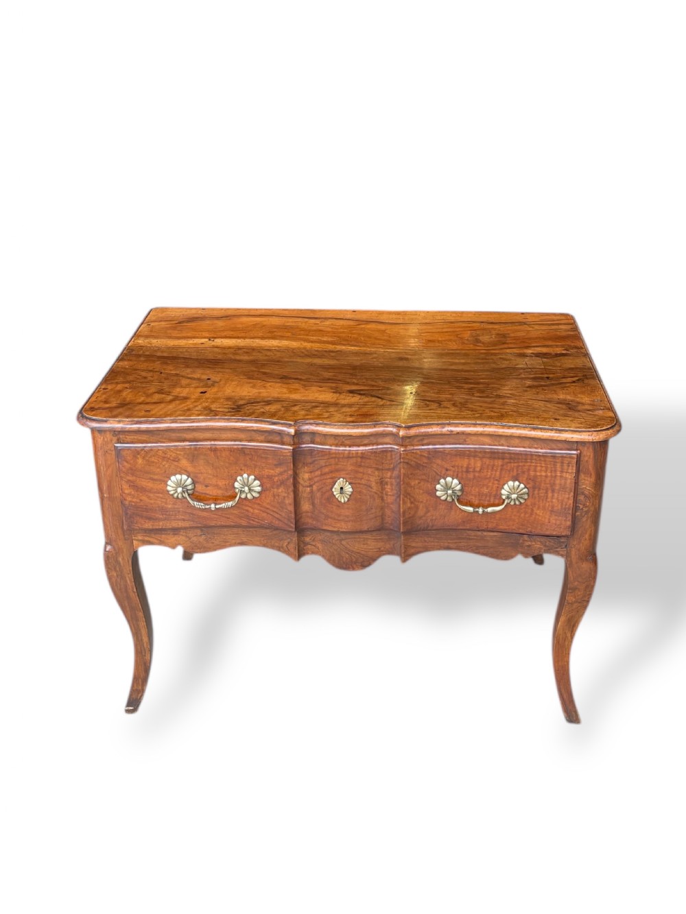 An 18th-century French walnut side table featuring a contoured serpentine front, single drawer with decorative brass handles, a shaped apron, and curved cabriole legs. View V