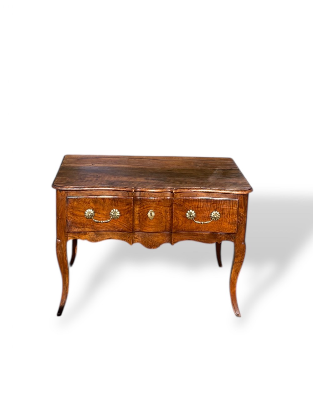An 18th-century French walnut side table featuring a contoured serpentine front, single drawer with decorative brass handles, a shaped apron, and curved cabriole legs. View VII