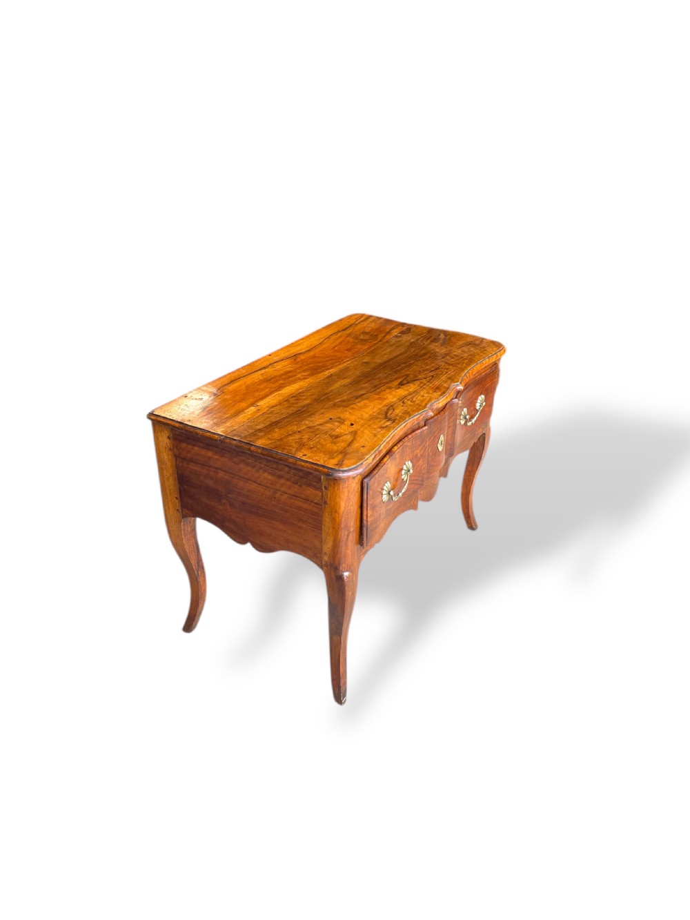 An 18th-century French walnut side table featuring a contoured serpentine front, single drawer with decorative brass handles, a shaped apron, and curved cabriole legs. View XIII