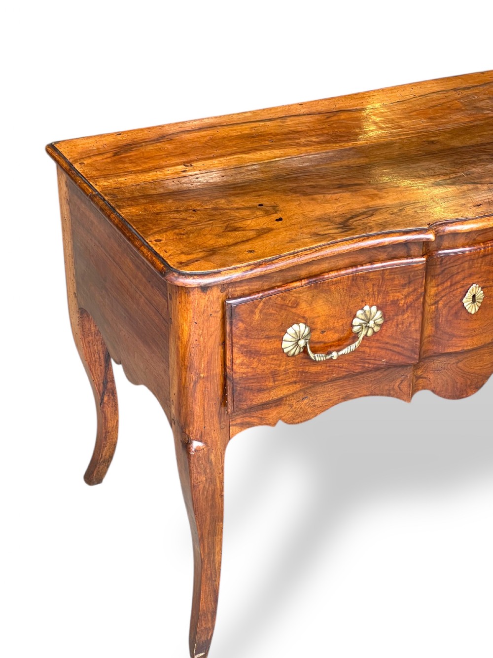 An 18th-century French walnut side table featuring a contoured serpentine front, single drawer with decorative brass handles, a shaped apron, and curved cabriole legs. View XIV