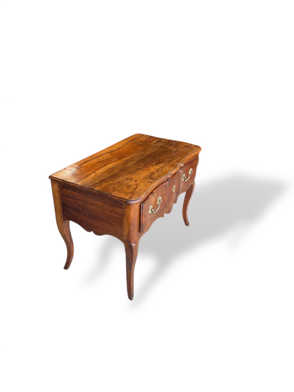 An 18th-century French walnut side table featuring a contoured serpentine front, single drawer with decorative brass handles, a shaped apron, and curved cabriole legs. View XV