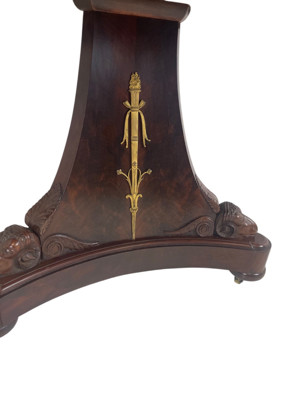 An early nineteenth-century French Empire gueridon table with a circular grey veined marble top resting on a mahogany base with carved ram heads. View III