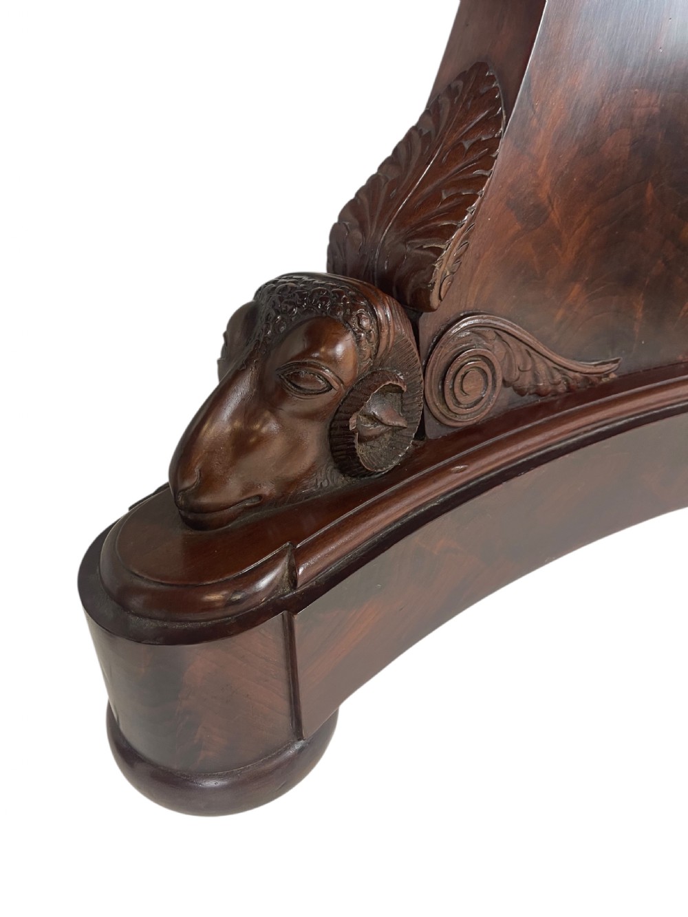 An early nineteenth-century French Empire gueridon table with a circular grey veined marble top resting on a mahogany base with carved ram heads. View V