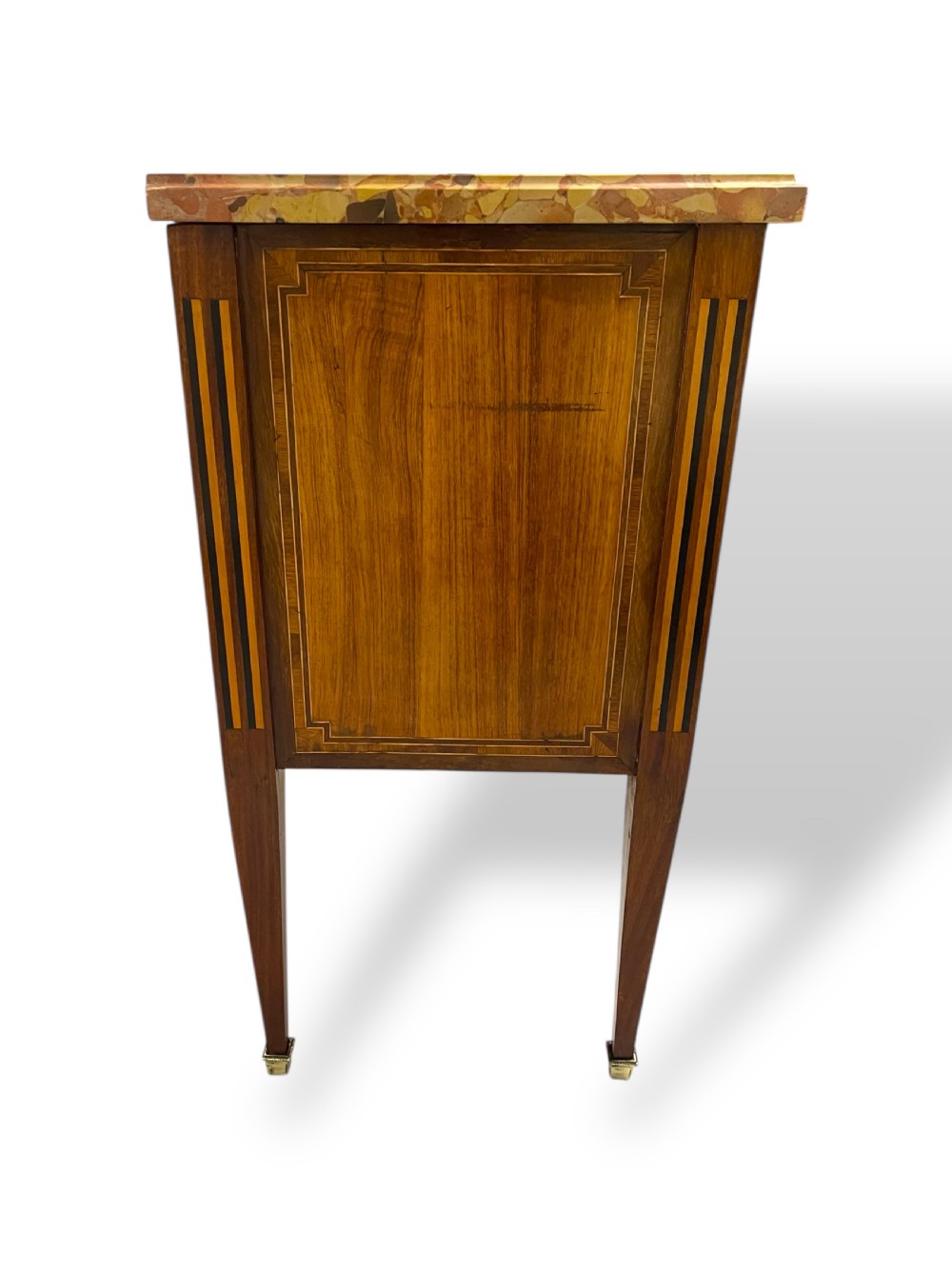 A Louis XVI style wooden commode featuring geometric parquetry inlay, a variegated marble top, three drawers with brass escutcheons, and tapered square legs. View XI