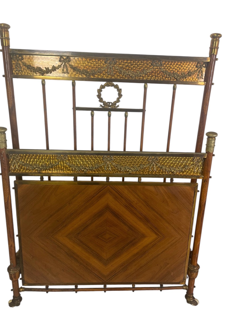 A pair of Edwardian brass and walnut single bed frames featuring diamond veneer panels and brass swag detailing. View II