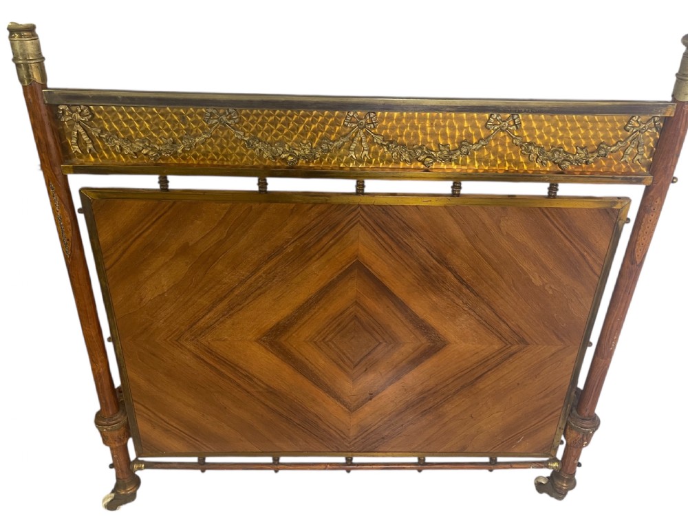 A pair of Edwardian brass and walnut single bed frames featuring diamond veneer panels and brass swag detailing. View III