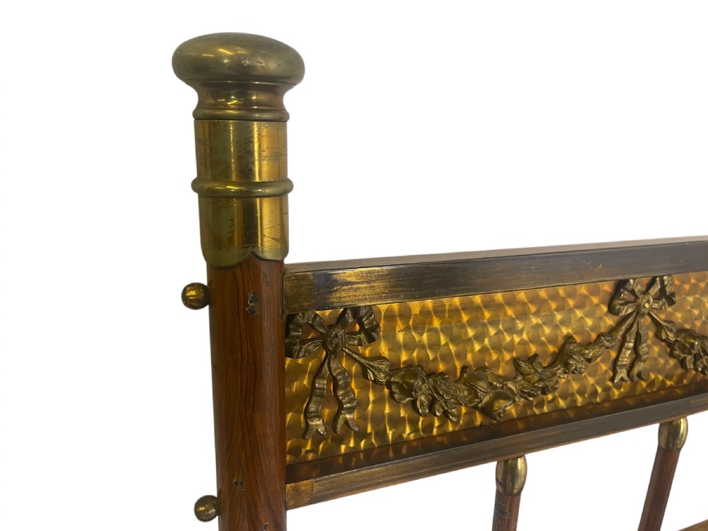 A pair of Edwardian brass and walnut single bed frames featuring diamond veneer panels and brass swag detailing. View IV