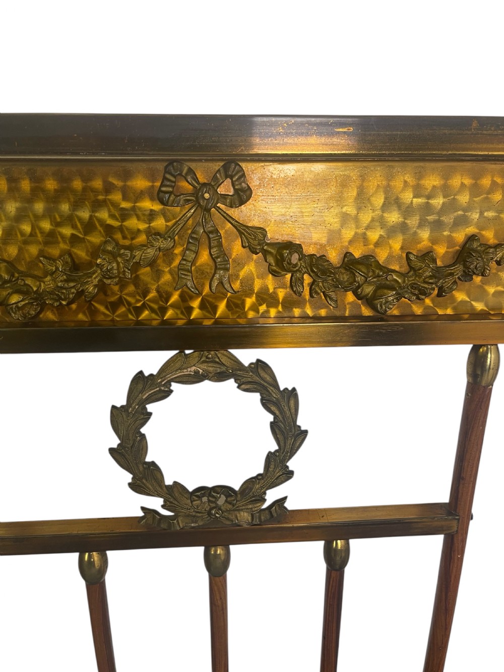 A pair of Edwardian brass and walnut single bed frames featuring diamond veneer panels and brass swag detailing. View V