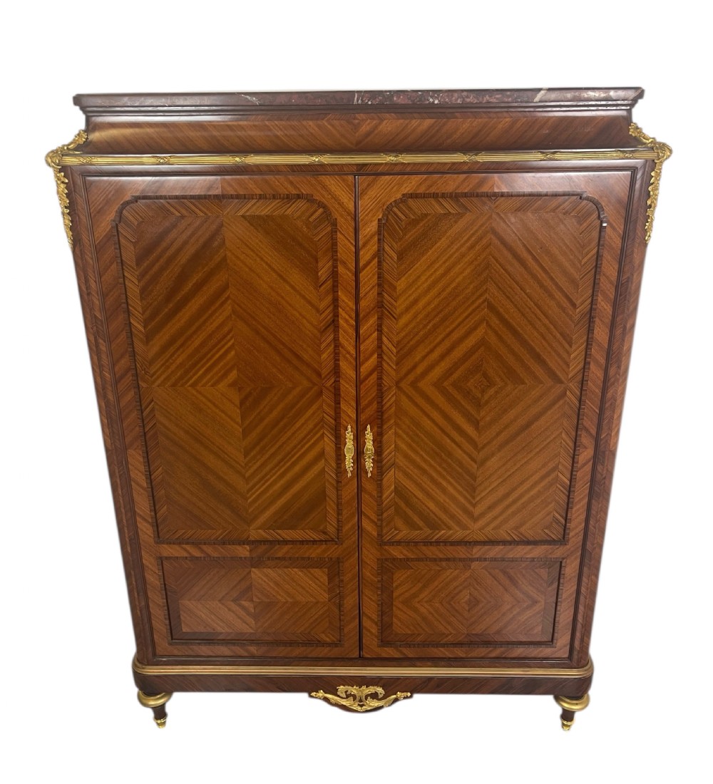 A French Louis XV style marquetry cabinet featuring geometric veneer panelling, gilt-bronze corner mounts, and a dark marble top.