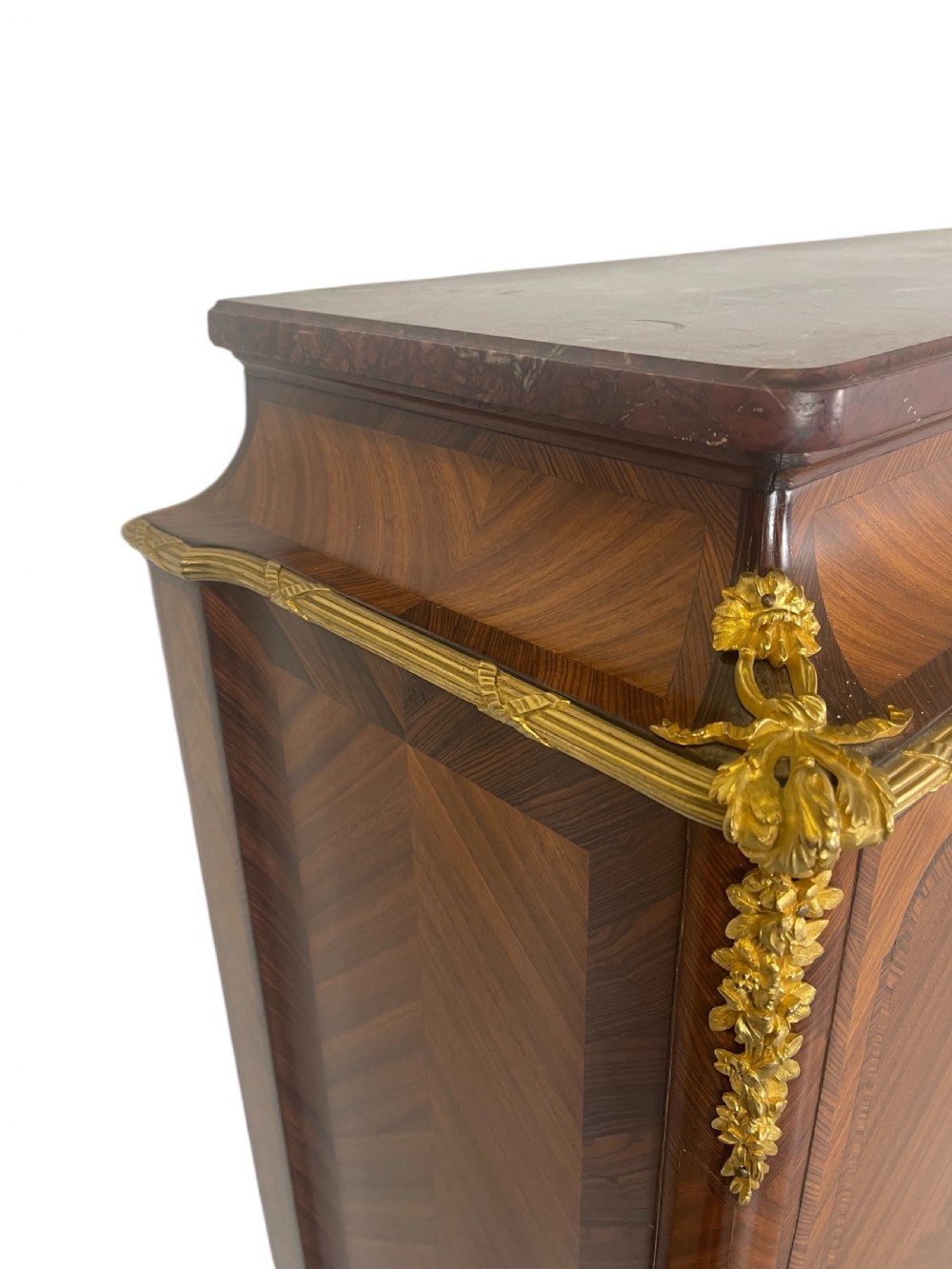 A French Louis XV style marquetry cabinet featuring geometric veneer panelling, gilt-bronze corner mounts, and a dark marble top. View V
