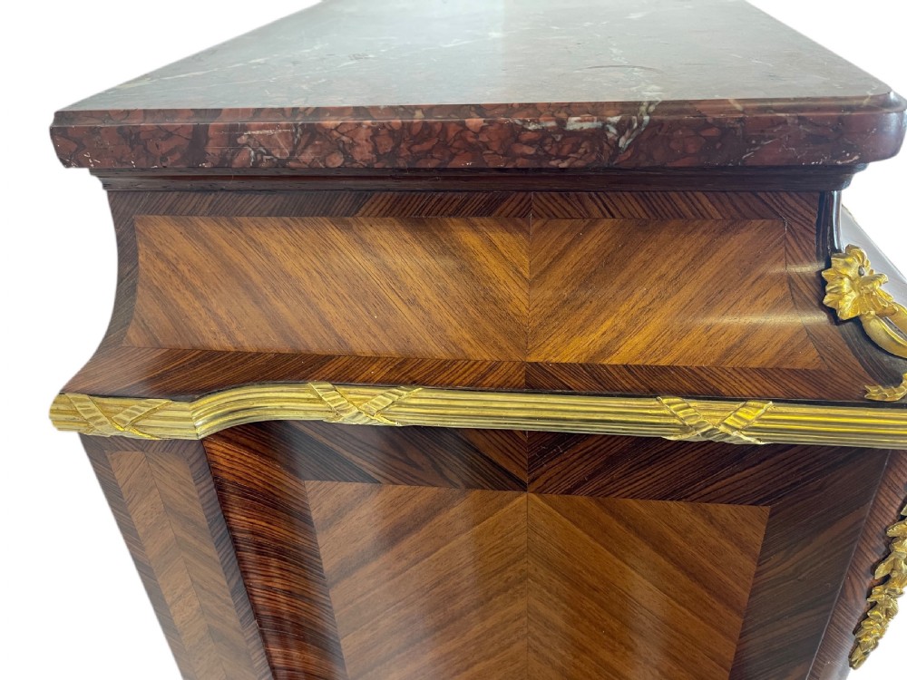 A French Louis XV style marquetry cabinet featuring geometric veneer panelling, gilt-bronze corner mounts, and a dark marble top. View VI