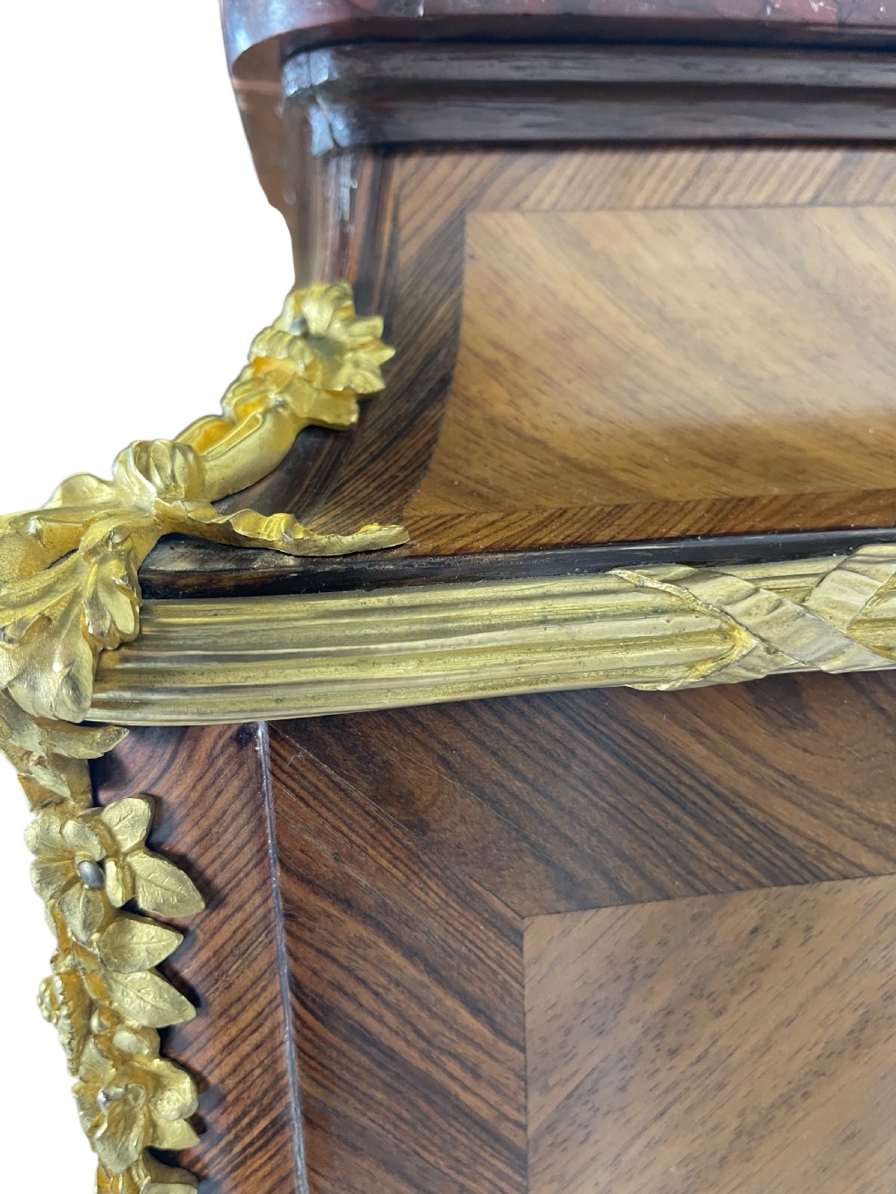 A French Louis XV style marquetry cabinet featuring geometric veneer panelling, gilt-bronze corner mounts, and a dark marble top. View XIII