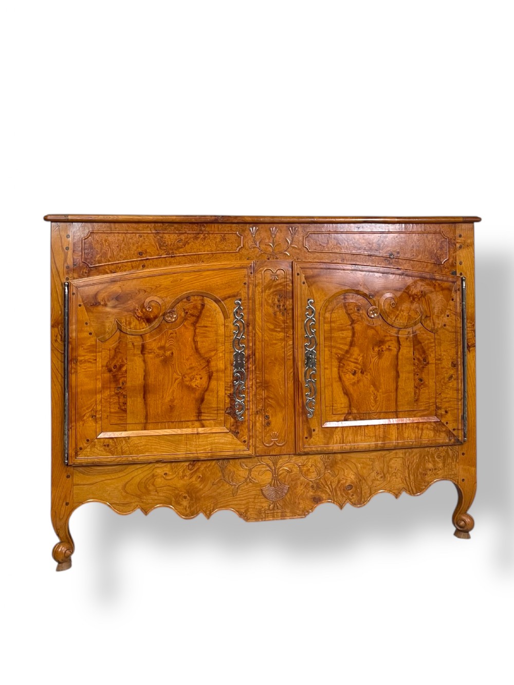 A French burr elm provincial dresser featuring two panelled doors with intricate grain patterns, steel escutcheons, a carved apron, and cabriole legs. View III
