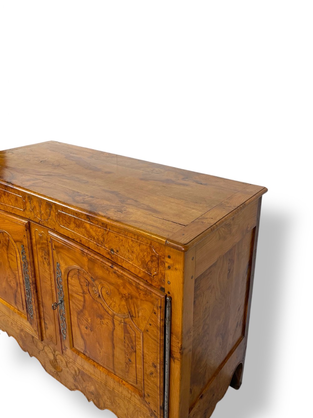 A French burr elm provincial dresser featuring two panelled doors with intricate grain patterns, steel escutcheons, a carved apron, and cabriole legs. View IX