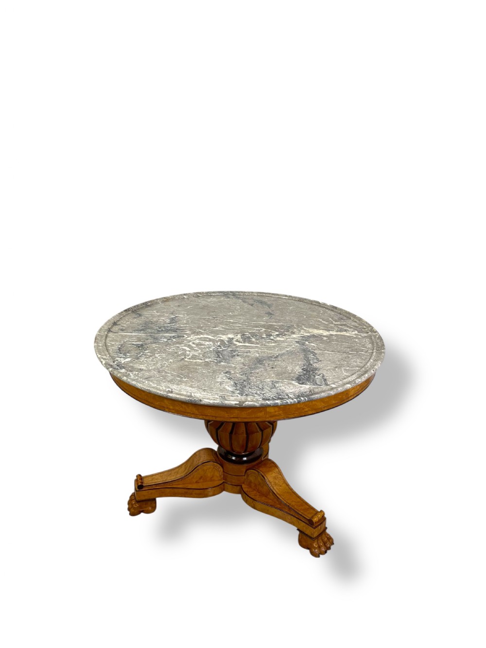 A circular antique French Empire gueridon table featuring a grey-veined marble top on a carved wooden pedestal with a triform base and lion paw feet. View II