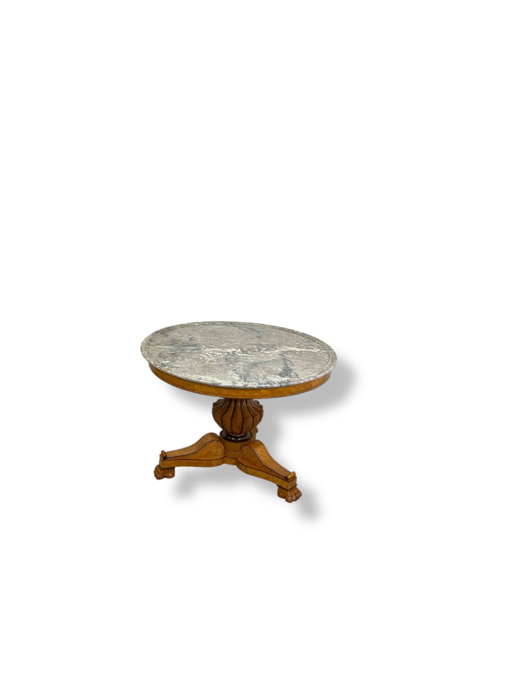 A circular antique French Empire gueridon table featuring a grey-veined marble top on a carved wooden pedestal with a triform base and lion paw feet. View III