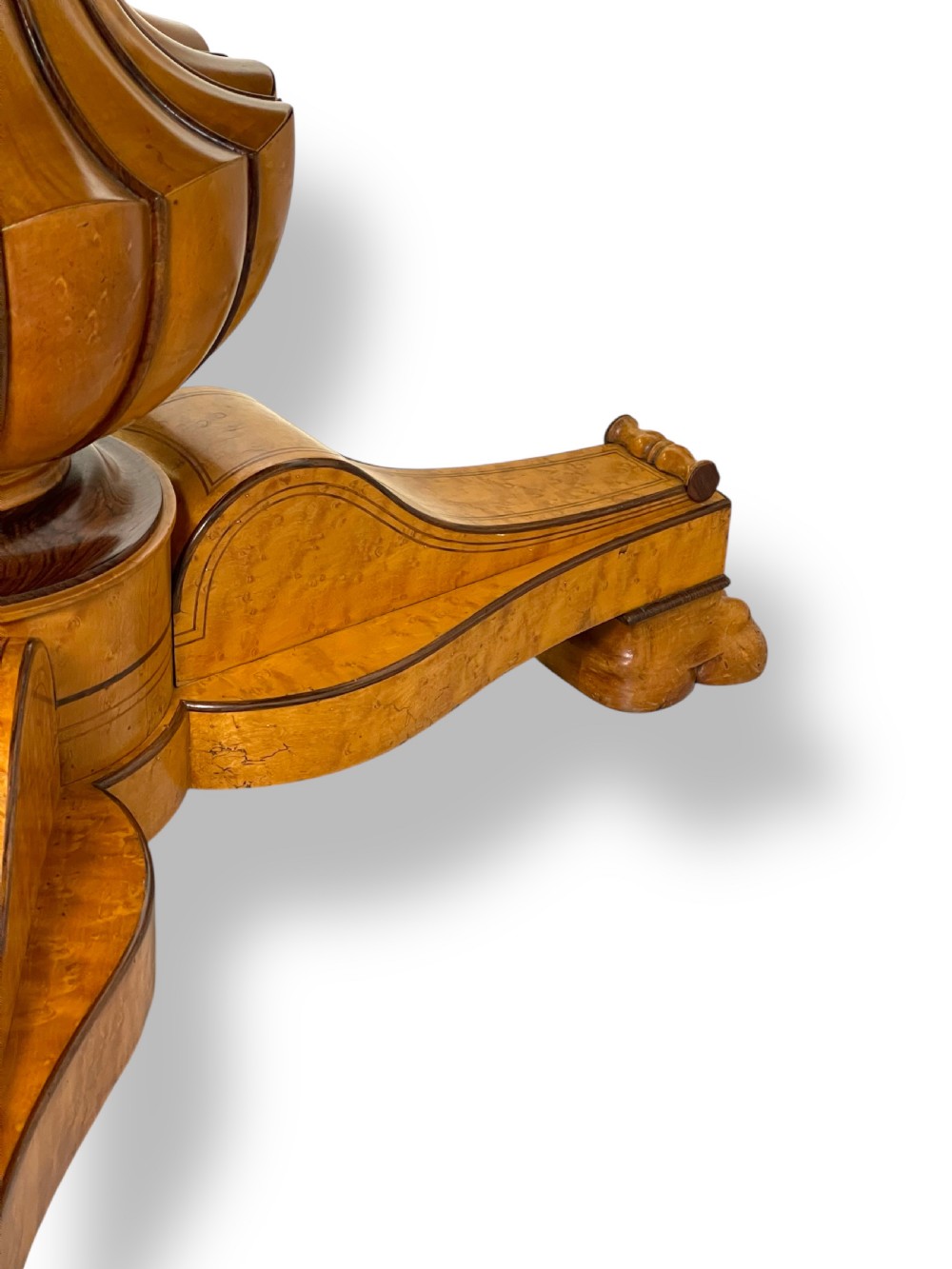 A circular antique French Empire gueridon table featuring a grey-veined marble top on a carved wooden pedestal with a triform base and lion paw feet. View IX