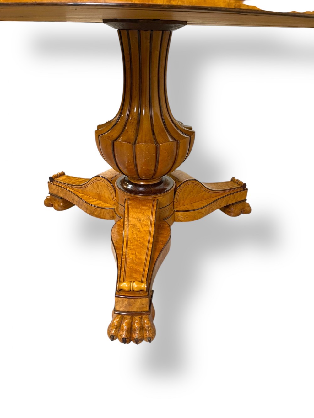 A circular antique French Empire gueridon table featuring a grey-veined marble top on a carved wooden pedestal with a triform base and lion paw feet. View X