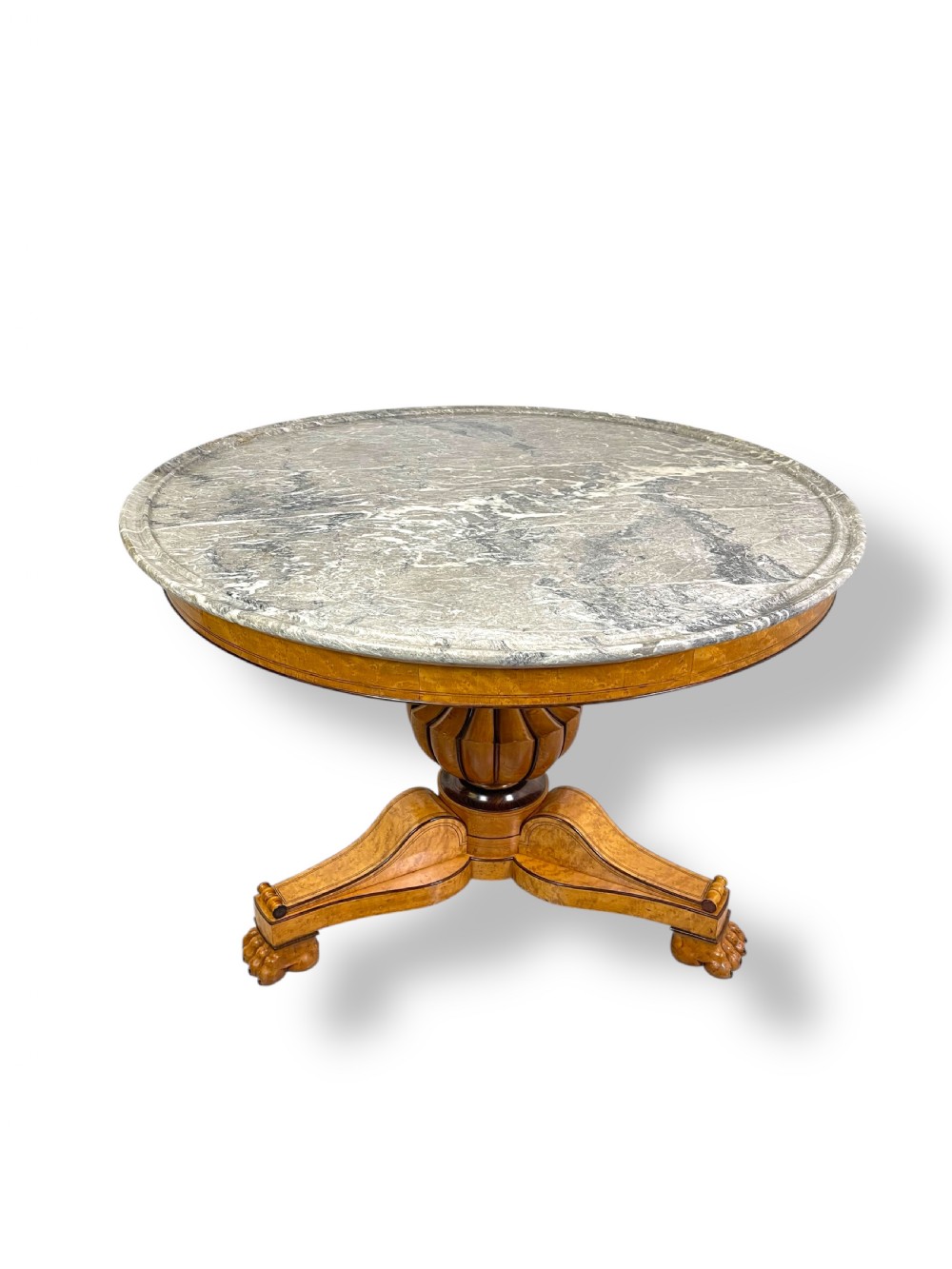 A circular antique French Empire gueridon table featuring a grey-veined marble top on a carved wooden pedestal with a triform base and lion paw feet. View XII