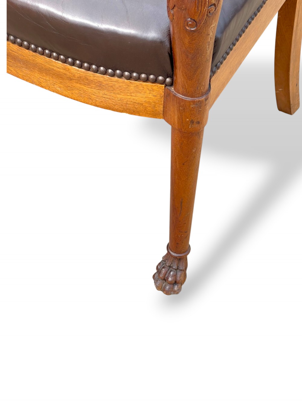 A pair of twentieth-century French Empire style armchairs featuring carved mahogany frames, dark brown leather upholstery, and brass stud trim. View XI