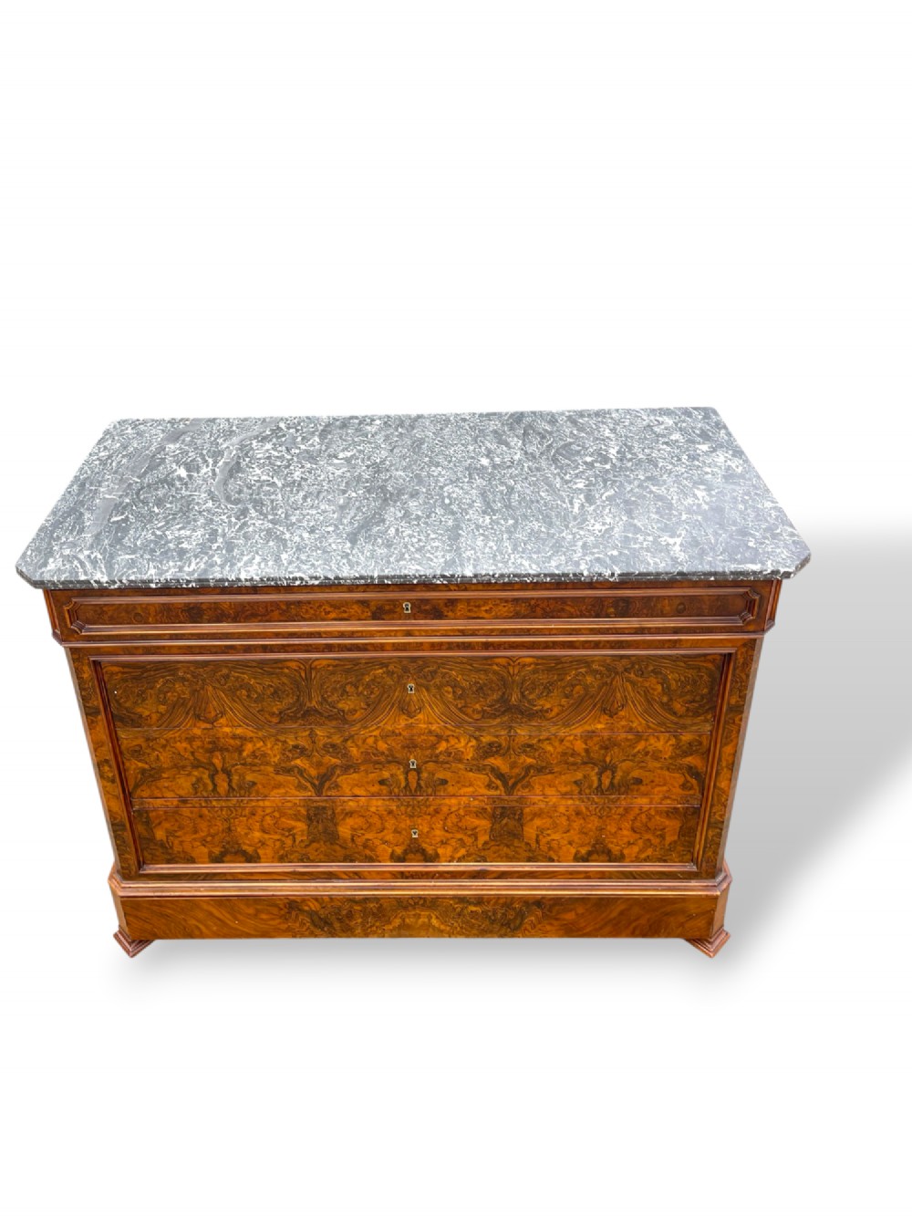 A 19th-century French Louis Philippe walnut commode featuring a grey marble top surface and figured walnut timber drawers with brass keyhole escutcheons. View VI