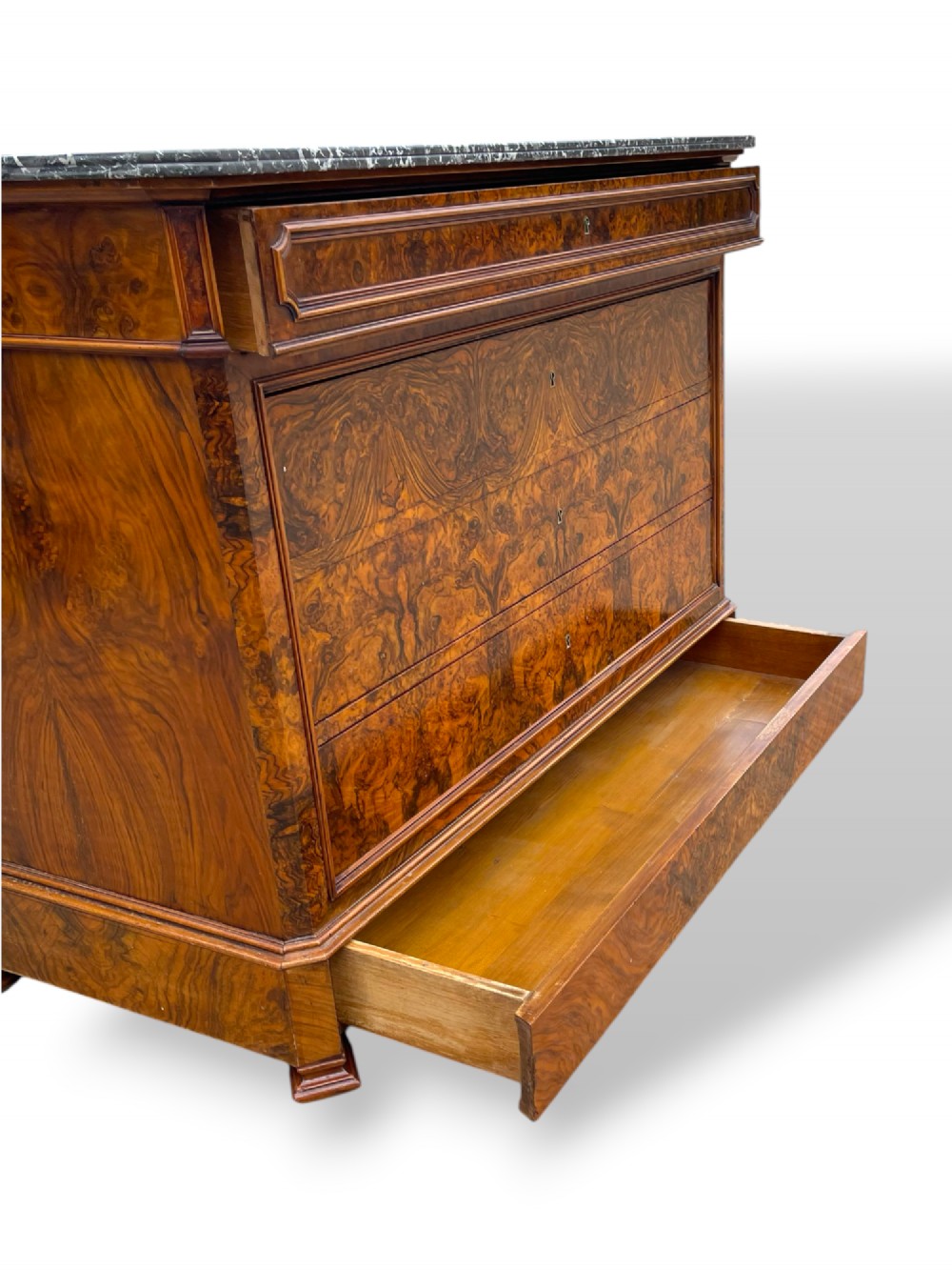 A 19th-century French Louis Philippe walnut commode featuring a grey marble top surface and figured walnut timber drawers with brass keyhole escutcheons. View VIII