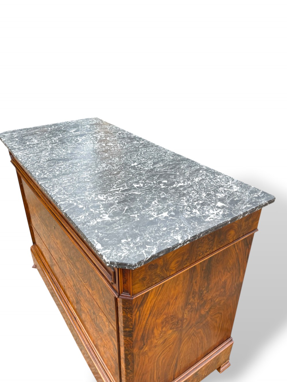 A 19th-century French Louis Philippe walnut commode featuring a grey marble top surface and figured walnut timber drawers with brass keyhole escutcheons. View IX