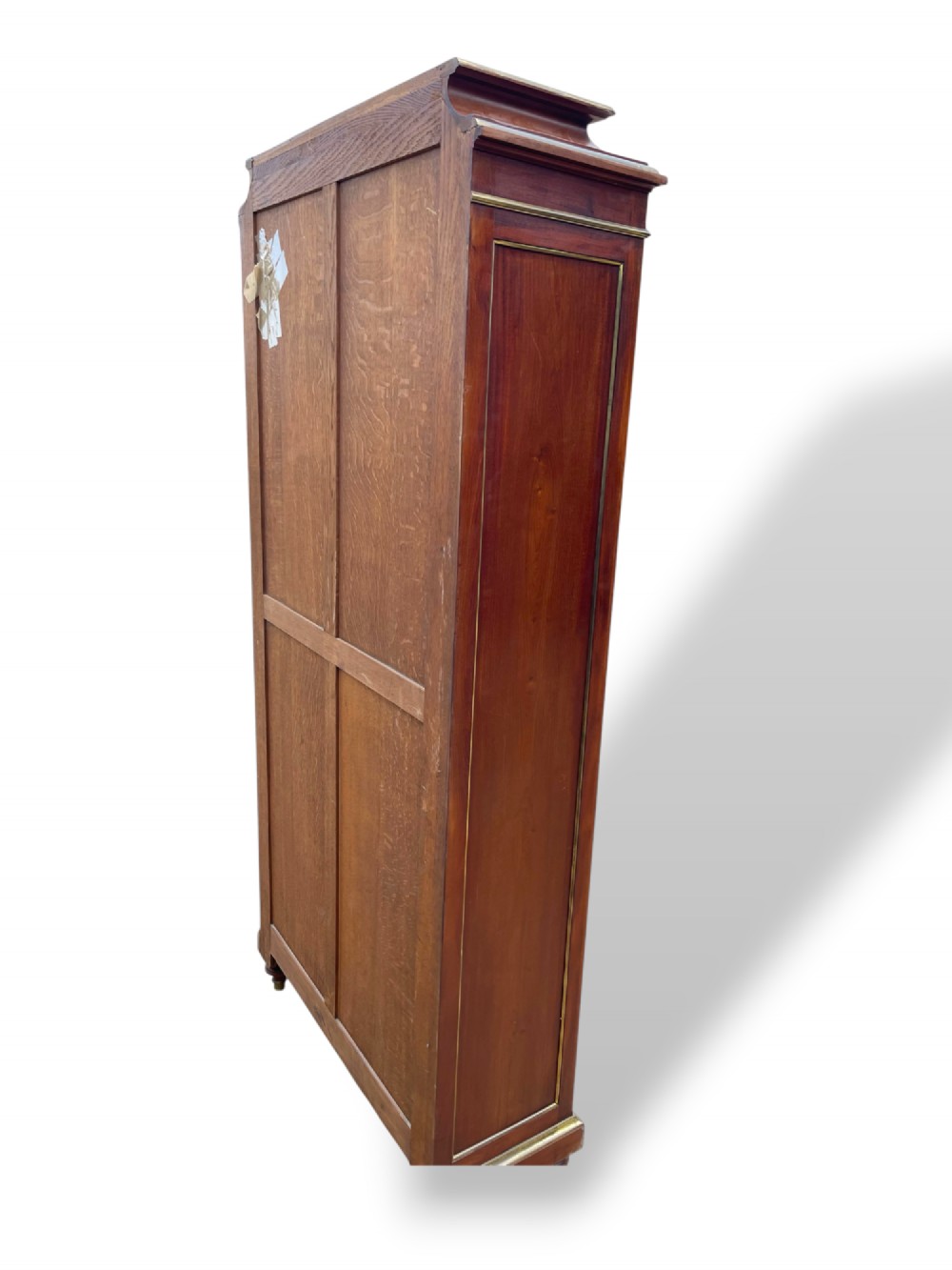 A tall French Empire style mahogany two-door bookcase featuring brass wire mesh door panels and fluted side columns. View V