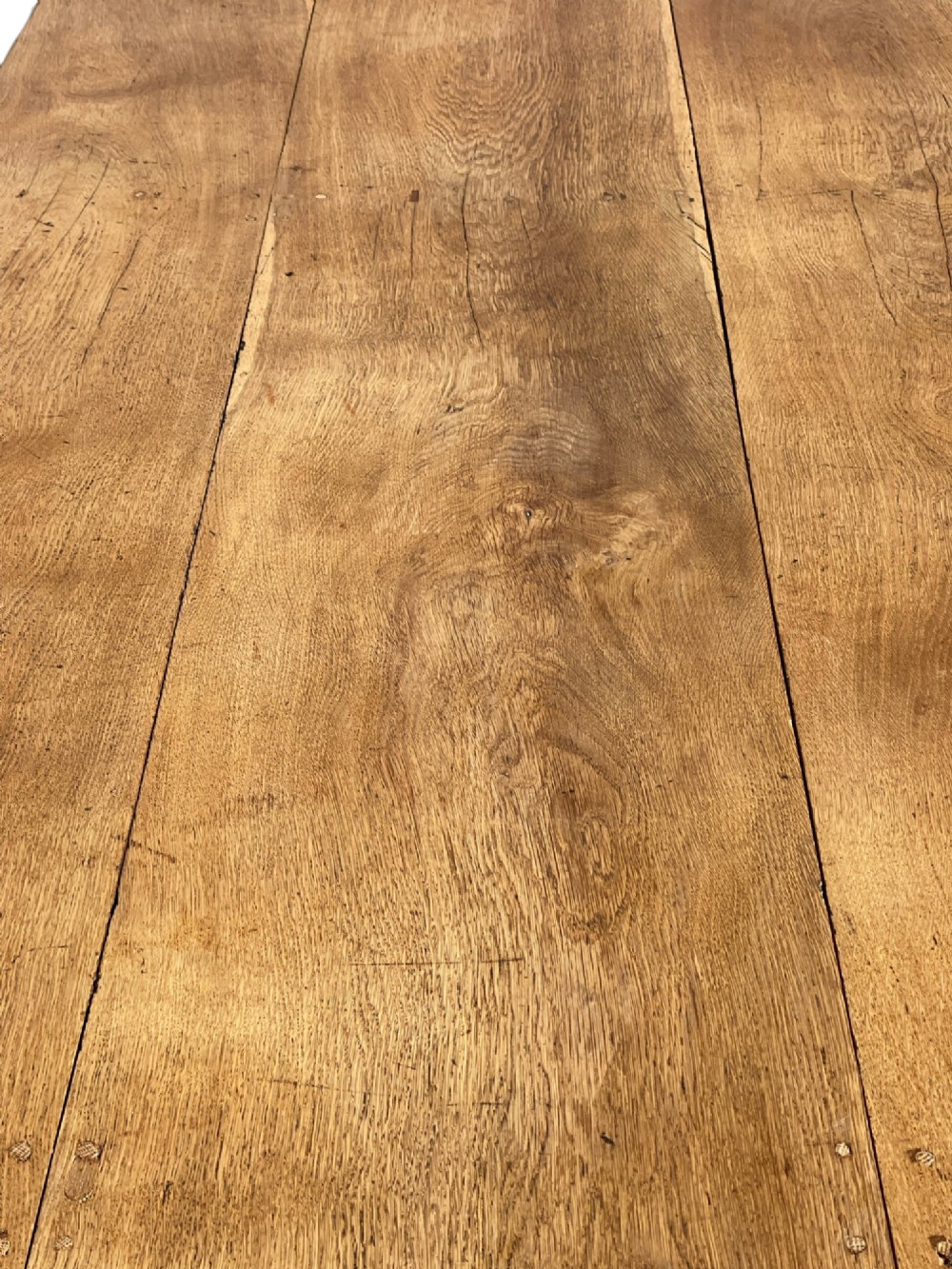 A large 19th-century English oak low coffee table featuring a three-plank top and trestle legs with heart-shaped cutouts connected by a central stretcher. View XIII