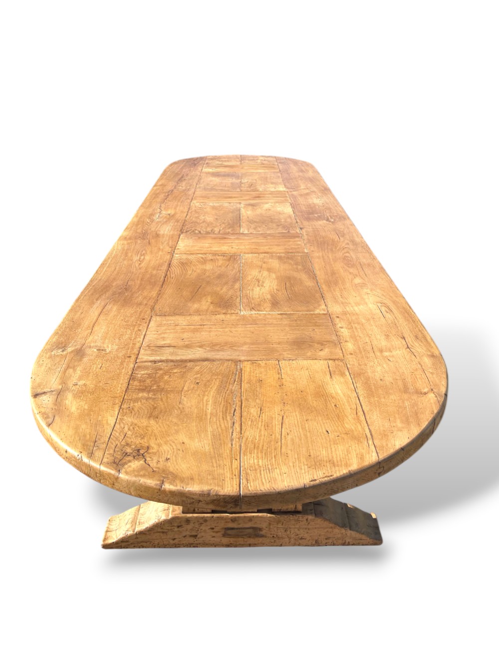 A four-metre French oak refectory dining table with rounded ends, a panelled timber top, and turned baluster legs set on trestle bases. View VI
